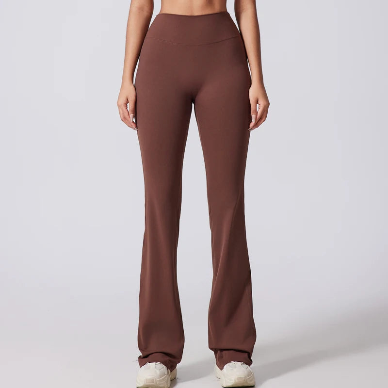 Brown high-waisted pants worn by a person on a white background