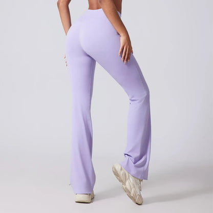 Person wearing lavender flared pants on a plain background