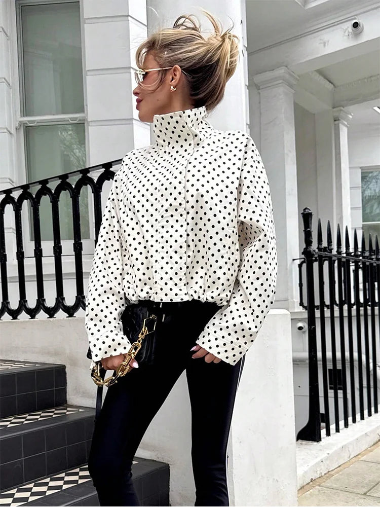 Woman posing in polka dot windbreaker activewear 