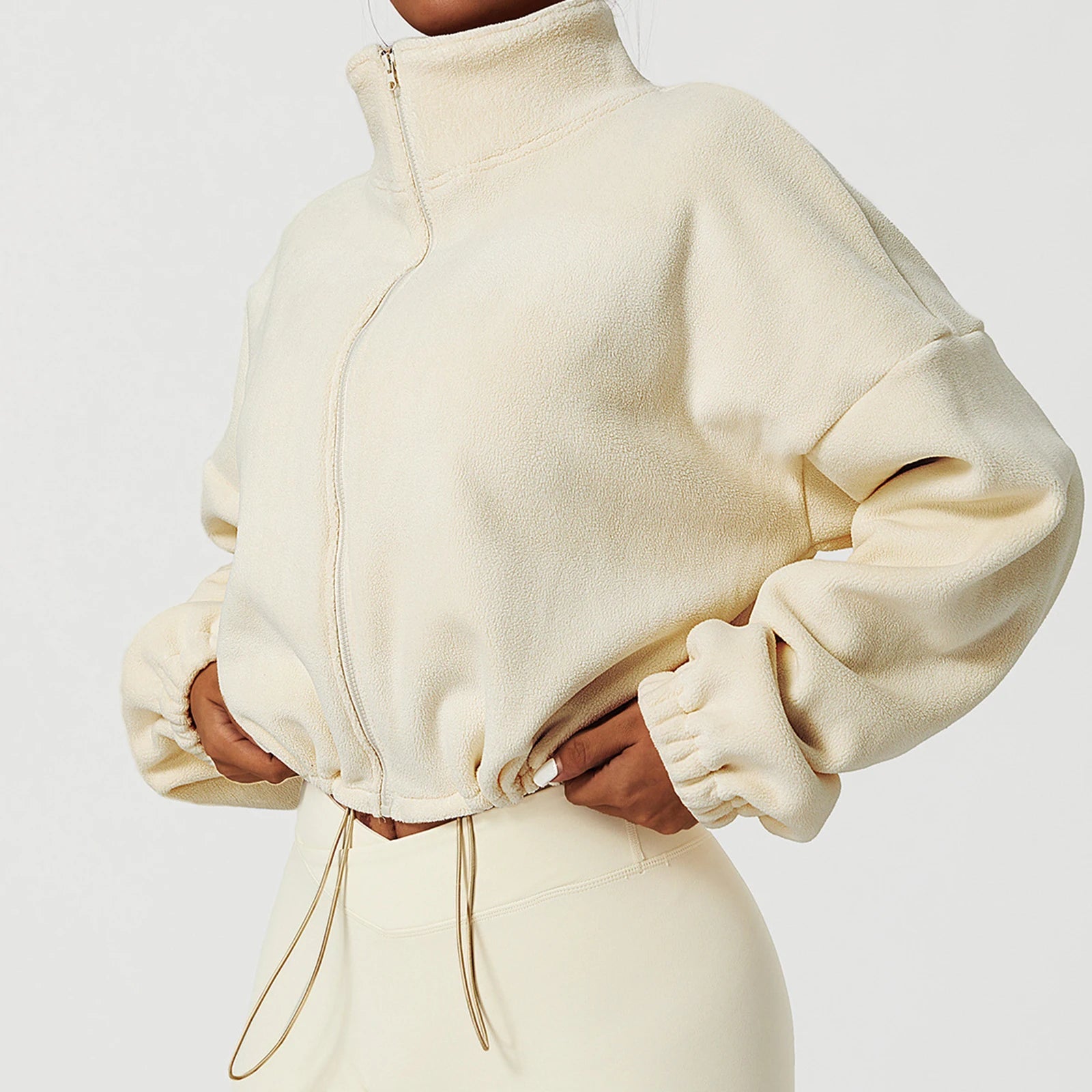 Model wearing cream Summit Sherpa Crop Zip jacket