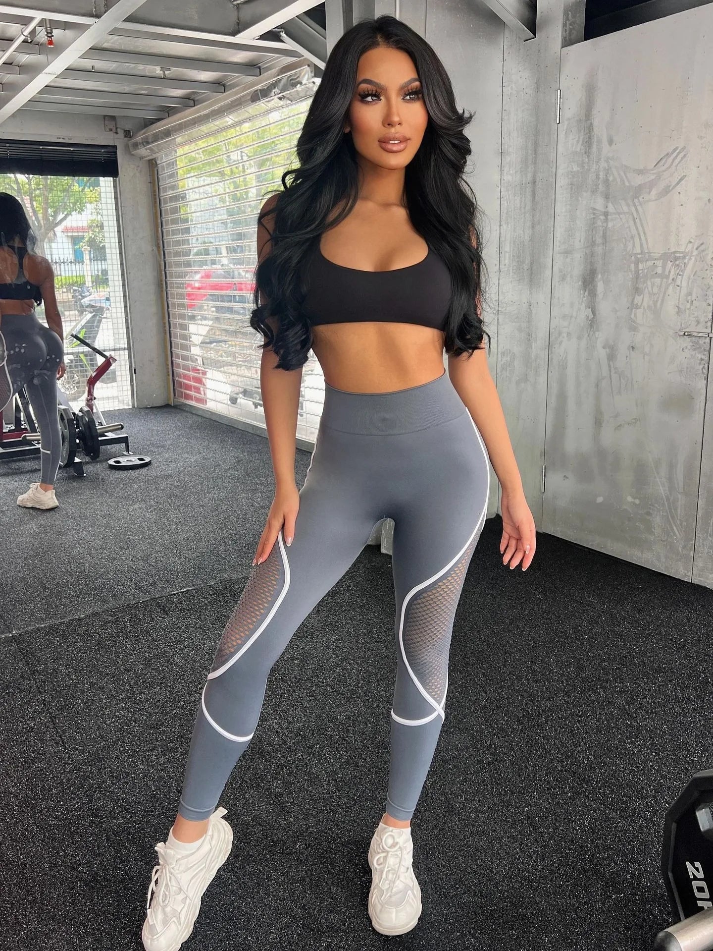 Model in gray-blue leggings with mesh inserts and curved seams – Stormshade tone