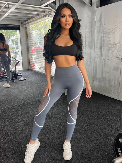 Model in gray-blue leggings with mesh inserts and curved seams – Stormshade tone