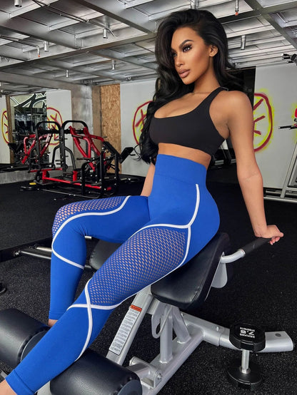 Model wearing electric blue contour mesh leggings with white seam detailing – VoltStream color
